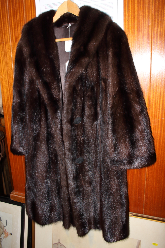 A full length mink coat with shawl collar