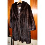 A full length mink coat with shawl collar