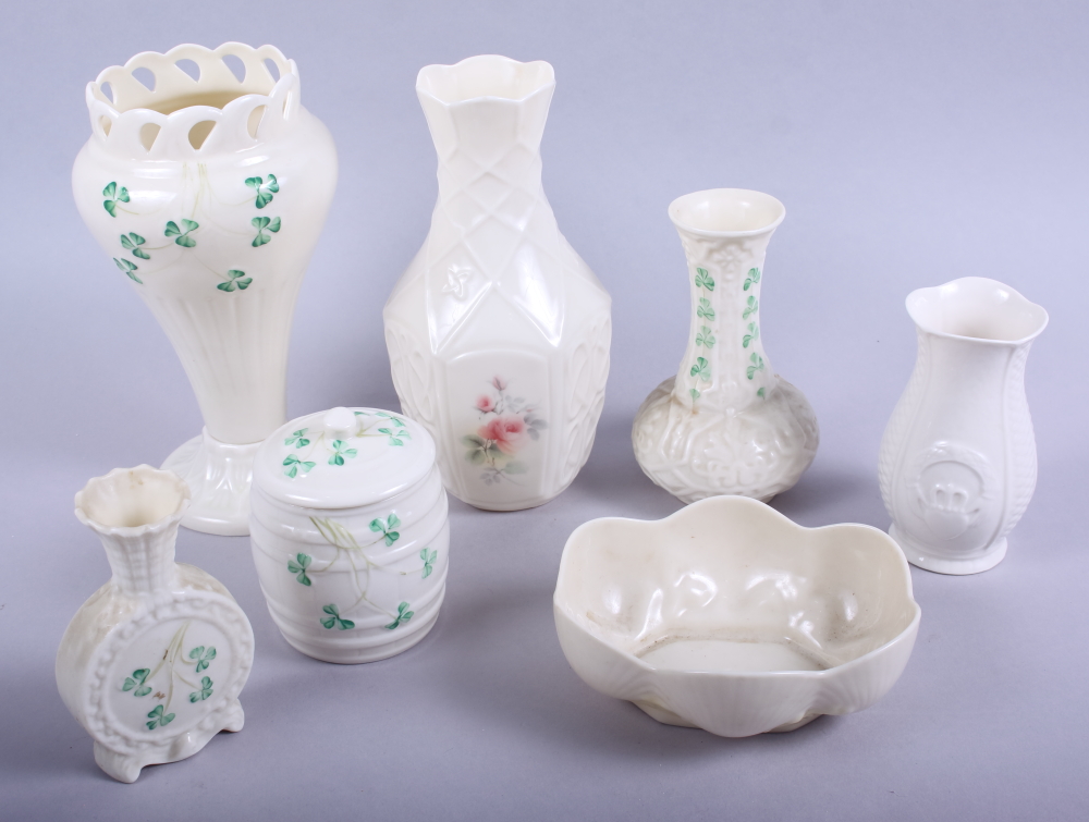 A Belleek vase with pierced rim, 7 3/4" high, a Belleek pot and cover, four other pieces of