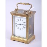 A brass and glass cased five-window carriage clock with white enamel dial and Roman numerals