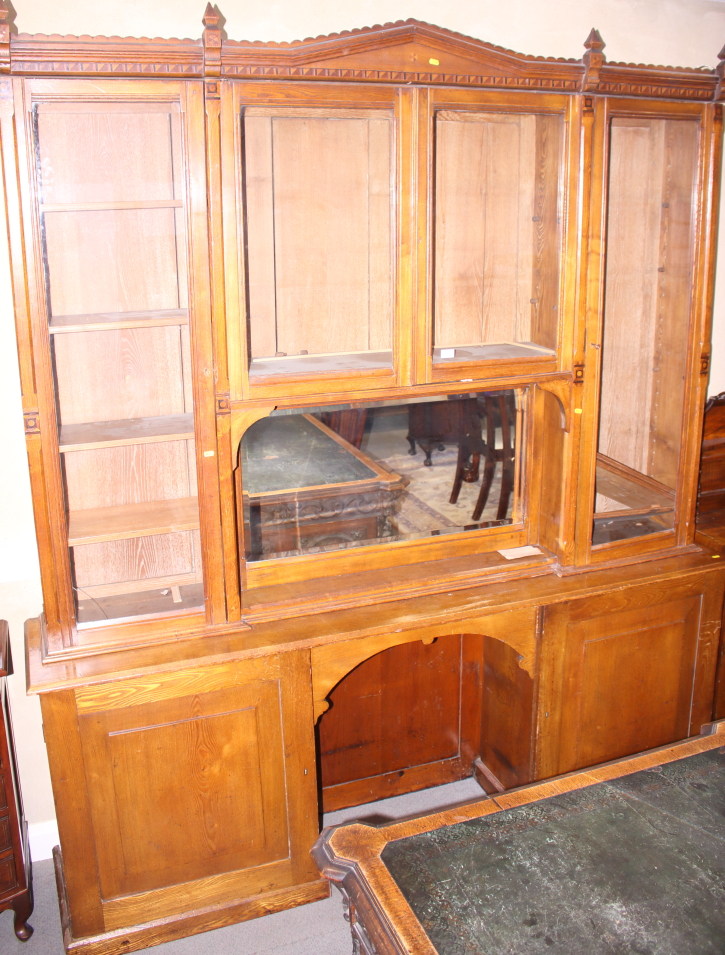 A late Victorian Aesthetic Movement ash, box and ebony inlaid bookcase enclosed by four glazed doors