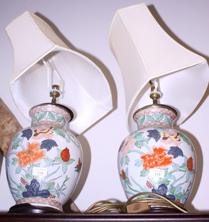 A pair of Chinese polychrome porcelain vases, now converted to table lamps, on turned wood bases,