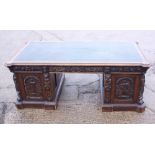 *A partners Victorian oak double pedestal desk with green leather tooled lined top, the pedestals