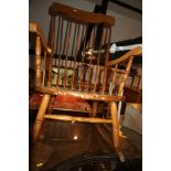 A Windsor stick back rocking chair with panel seat