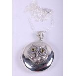 A white metal locket, decorated with an owl, on white metal chain, stamped 925
