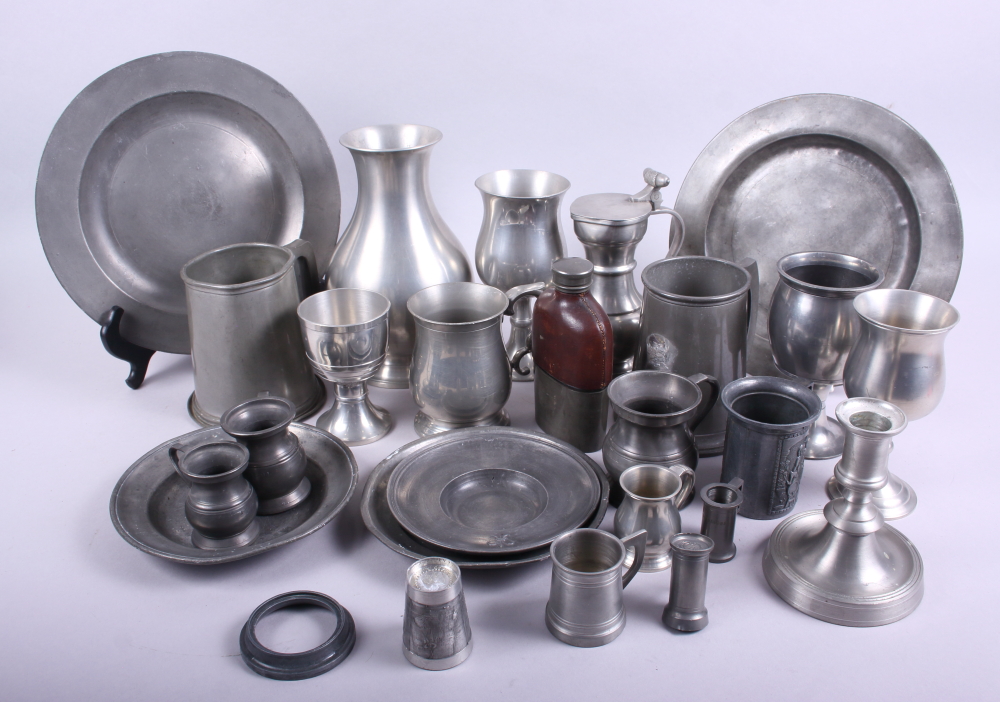 An assortment of pewter tankards and plates, various dates