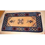 A Chinese hearth rug decorated vases on a blue ground, 48" x 24" approx