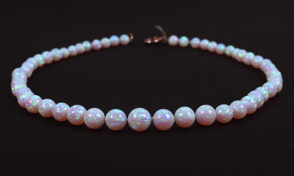 A graduated opalescent bead necklace, 18" long