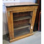 A Victorian walnut and inlaid pier cupboard with gilt metal mounts, enclosed glazed door, on block