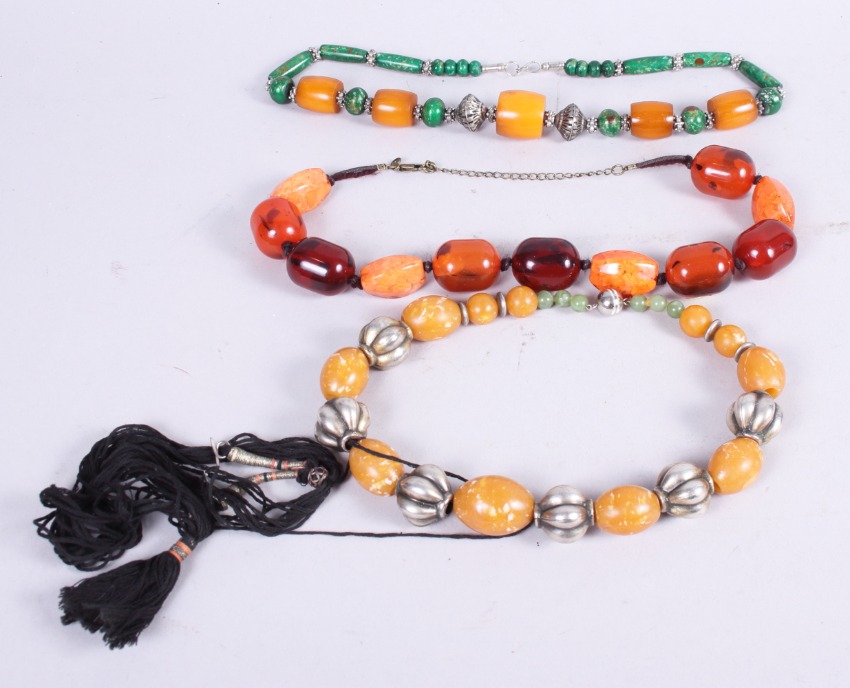 Three "Amber" necklaces, various