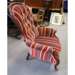 A Victorian mahogany showframe armchair, upholstered in a striped velvet, on cabriole castored