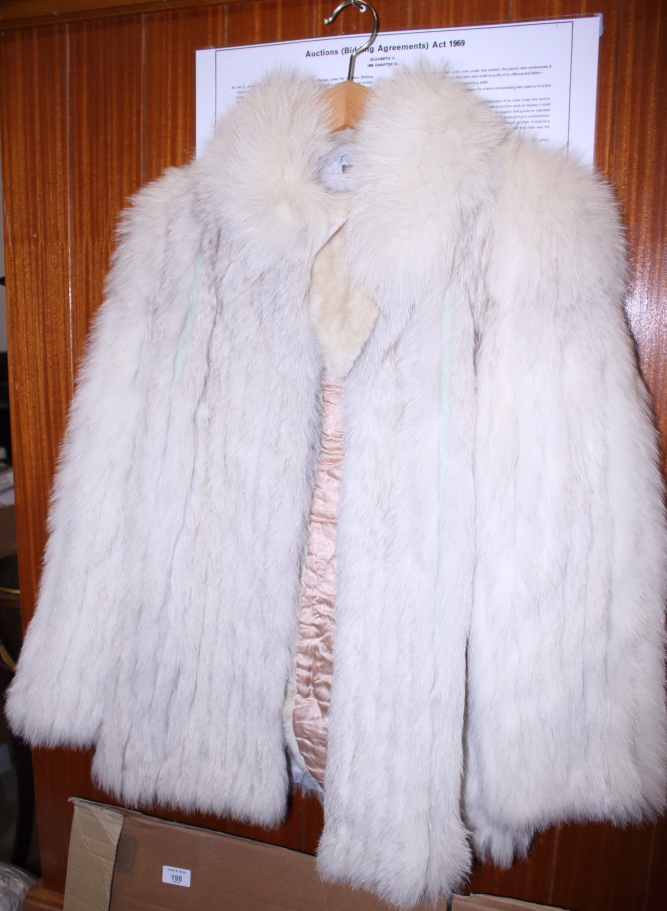 A fox fur gilet, a similar white jacket and a collar