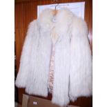 A fox fur gilet, a similar white jacket and a collar