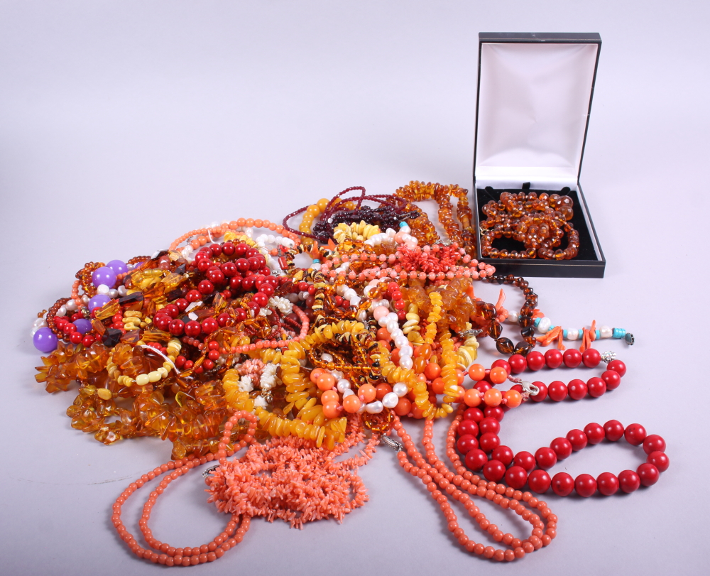 An assortment of beaded necklaces, amber necklaces and coral necklaces