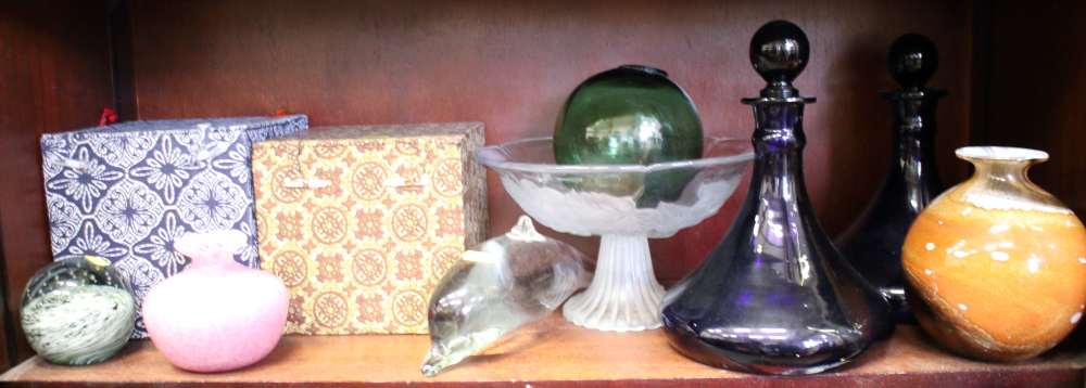 A pair of blue coloured glass decanters, a glass model of a dolphin, three glass balls, three