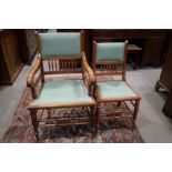 A set of six late 19th century walnut spindle back dining chairs with padded seat and back panels,