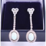 A pair of opal and cubic zirconia drop earrings
