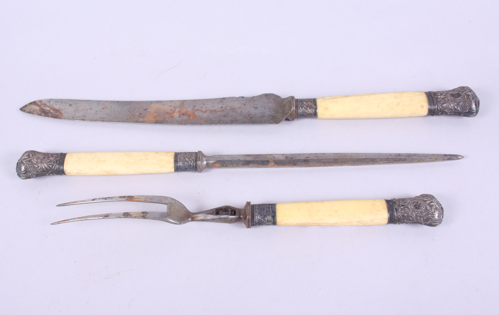 A Victorian three-piece carving set with silver mounted ivory handles (damages)