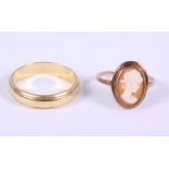 An 18ct gold wedding band, 5.7g, and a yellow metal cameo ring, stamped 9ct, 2.1g