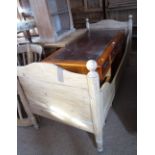 A child's French pine framed bed with panel ends and sides, on turned supports