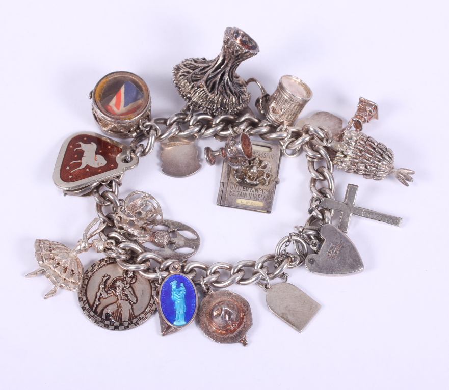 A silver charm bracelet mounted numerous white metal charms, 87.1g