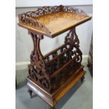 A Victorian walnut canterbury with gallery top of three divisions and drawer, on turned supports,