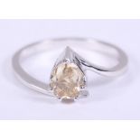 A pale brown pear-shaped solitaire diamond ring on cross-over shank, 0.9ct, size L 1/2,