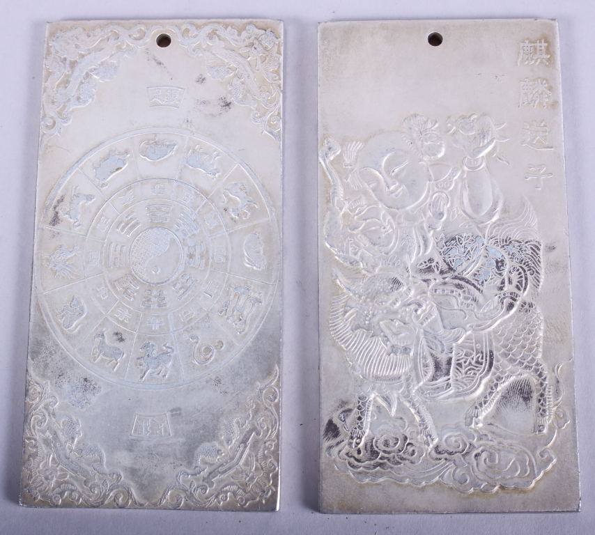 Two Chinese white metal scroll weights with embossed decoration, 4" high