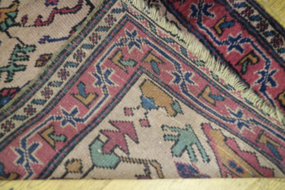 A Caucasian runner with all over geometric design on a dark ground in shades of red, blue and - Image 2 of 2