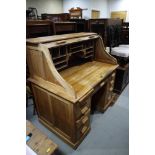 A hardwood roll-top desk, fitted pigeonholes over nine drawers, 48" wide