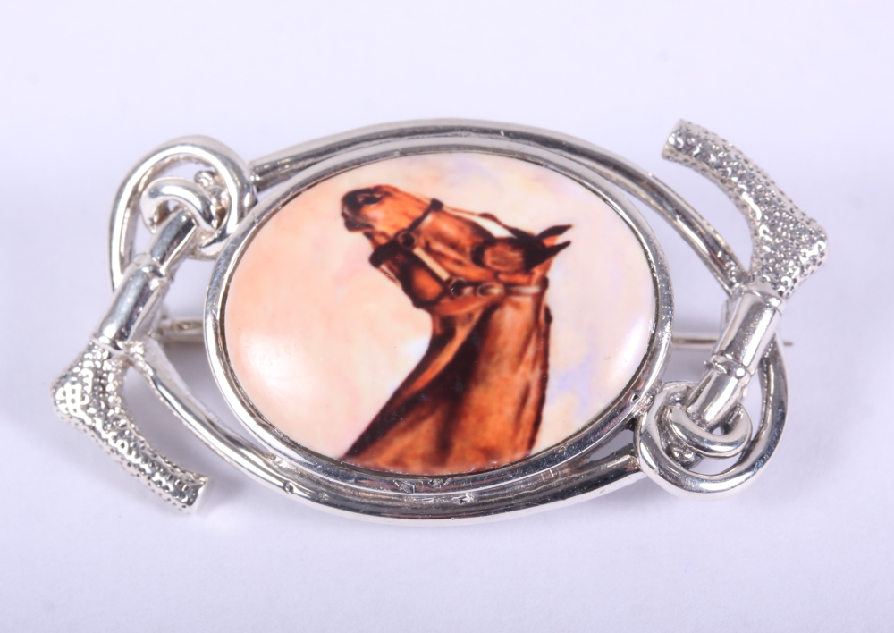 A white metal brooch, decorated with a horse, stamped 925