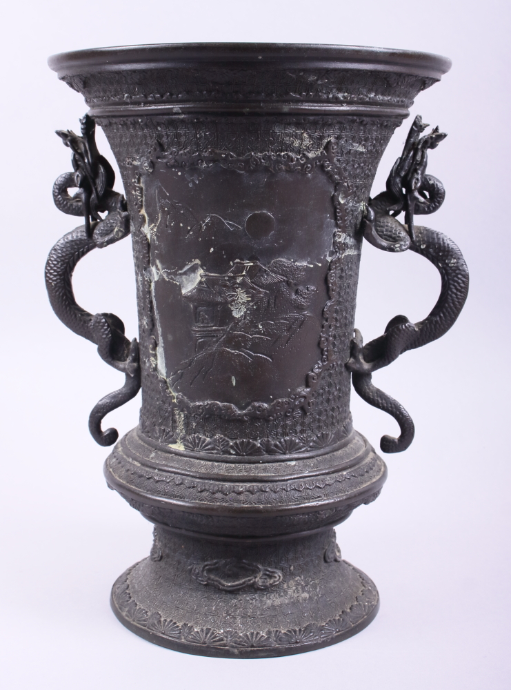 A Chinese bronze vase with two handles in the form of dragons and panels decorated landscape scenes,