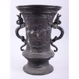 A Chinese bronze vase with two handles in the form of dragons and panels decorated landscape scenes,