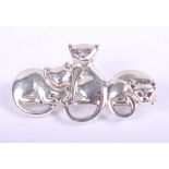 A white metal brooch, formed as three cats, stamped sterling