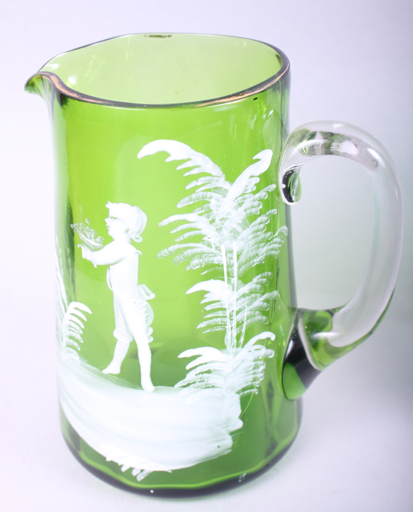 A Mary Gregory type green glass jug with figure decoration, a lily of the valley enamel jug, a