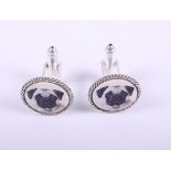 A pair of white metal cufflinks, decorated pug dogs