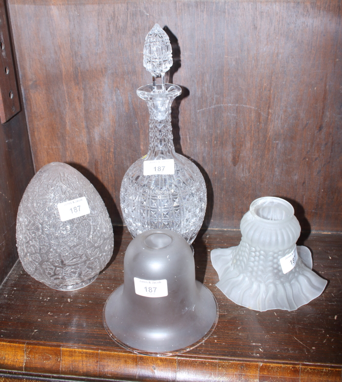 A 1920s cracked ice glass lampshade, two frosted glass lampshades and a cut glass decanter