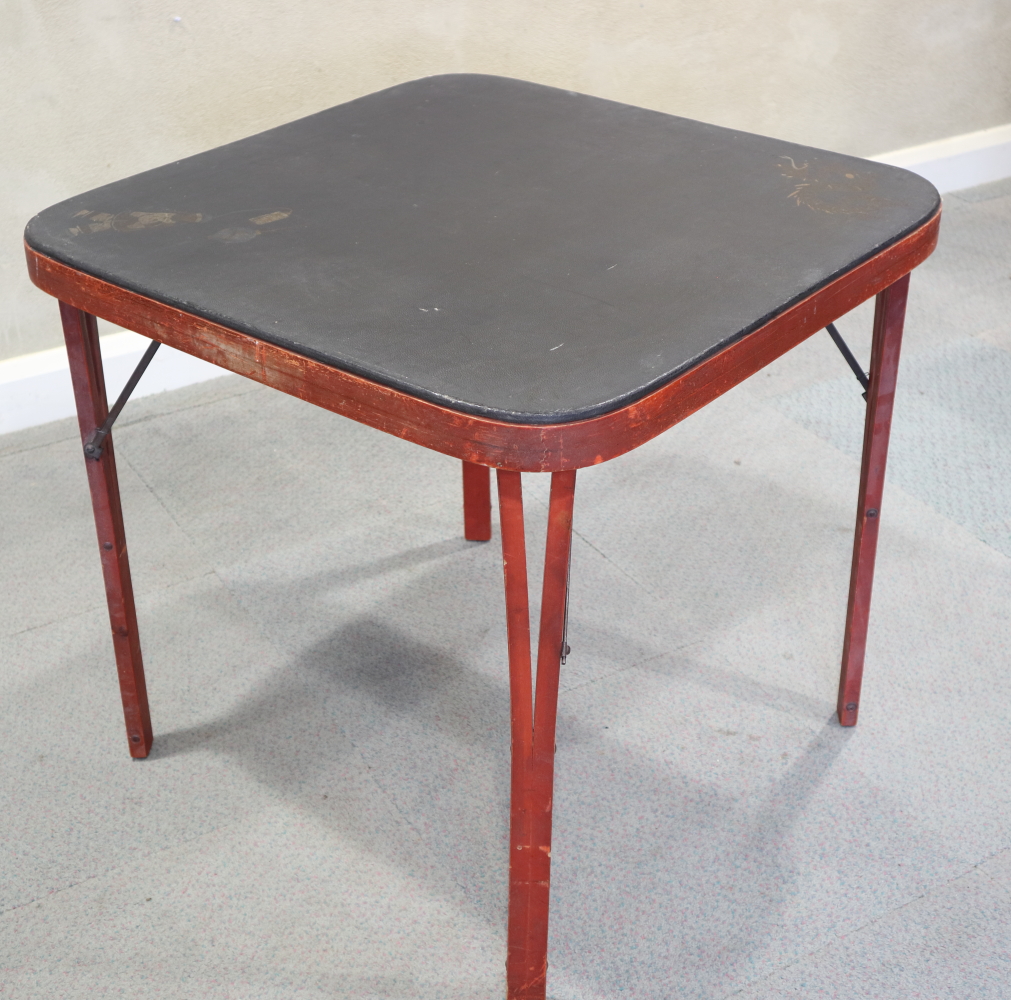 An early 20th century red lacquered folding mah-jong table, with tooled top, 28 1/2" square
