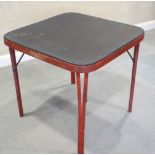 An early 20th century red lacquered folding mah-jong table, with tooled top, 28 1/2" square