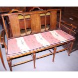An Edwardian mahogany two-seat chair back settle and a pair of matching elbow chairs, on turned