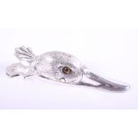 A white metal paper clip in the form of a duck's head with glass eyes