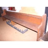 A pine pew, on panel end supports, 144" long approx