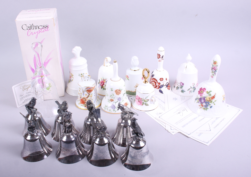 A limited edition Caithness crystal birthday bell, seven assorted ceramic bells and seven silvered
