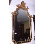 A gilt framed arch top and shaped plate mirror with shell crest, 35" x 18"