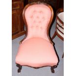 A Victorian mahogany showframe bedroom chair, upholstered in a salmon pink fabric, on cabriole