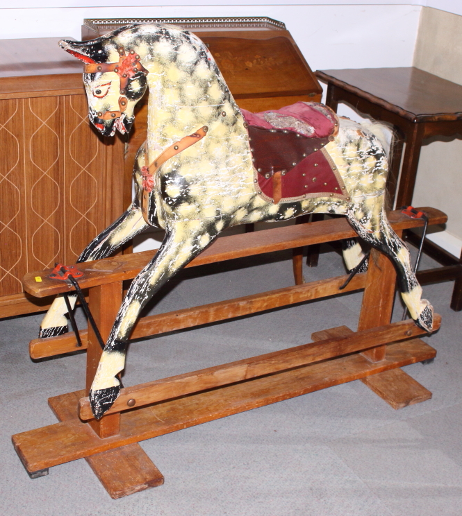 An early 20th century rocking horse, on wooden stand, 49 1/2" long