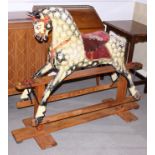 An early 20th century rocking horse, on wooden stand, 49 1/2" long