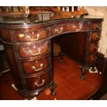 A late 19th century mahogany kidney-shaped writing desk with tooled lined top and blind fretted