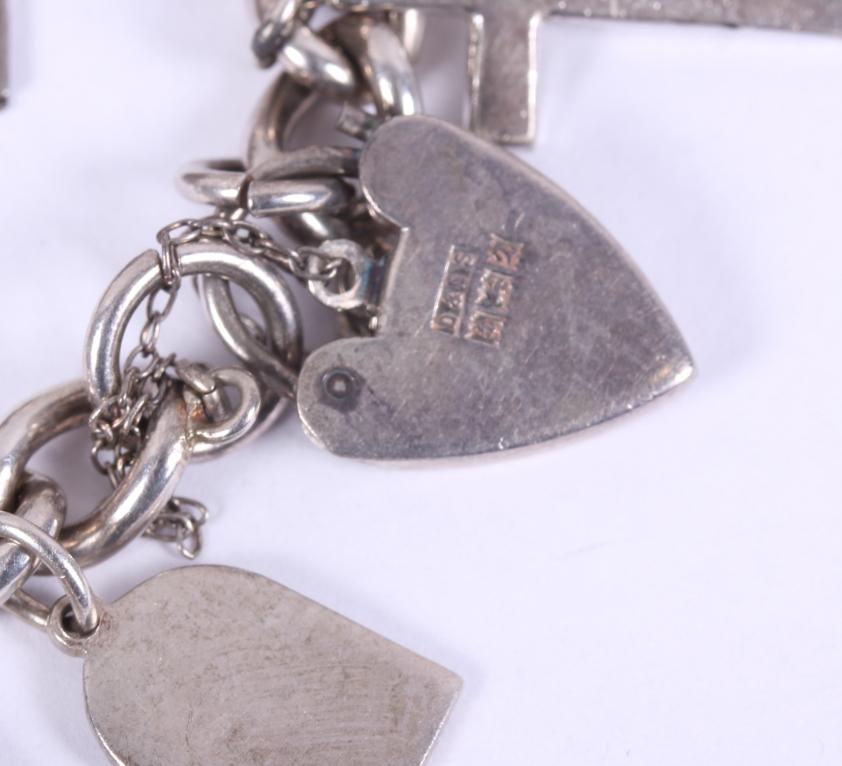 A silver charm bracelet mounted numerous white metal charms, 87.1g - Image 2 of 3
