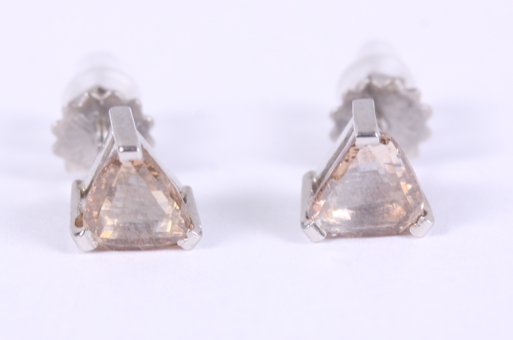 A pair of triangular solitaire diamond and white metal ear studs, stamped Plat 950